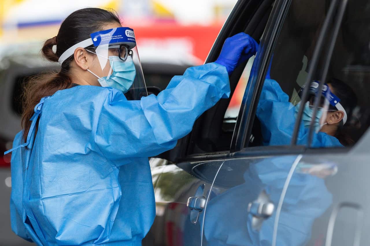 Medical staff are seen working at a drive-through COVID-19 testing clinic in Joondalup, north Perth.