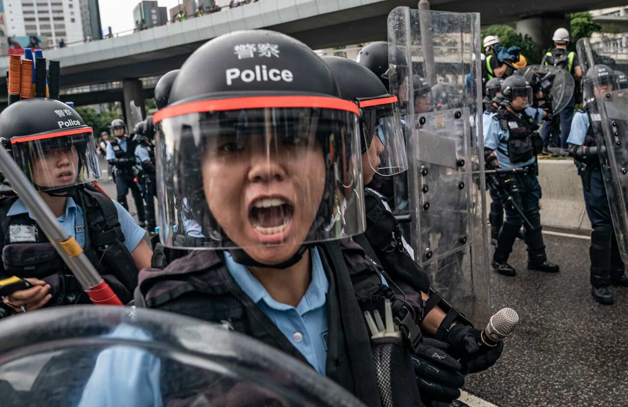 Police officers during a clash outside the Legislative Council Complex.