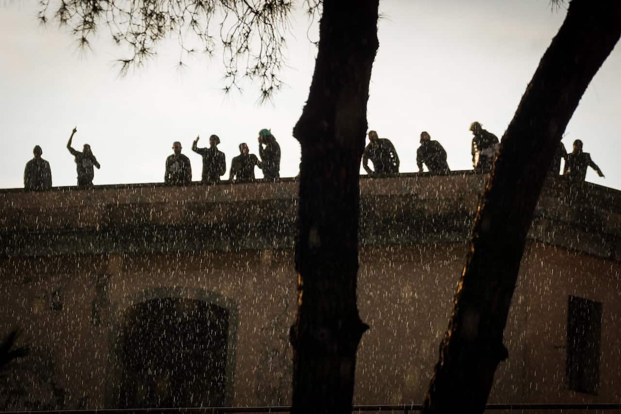 Inmates protest on a wall of the Poggioreale prison in Naples, Italy, 8 March, 2020.