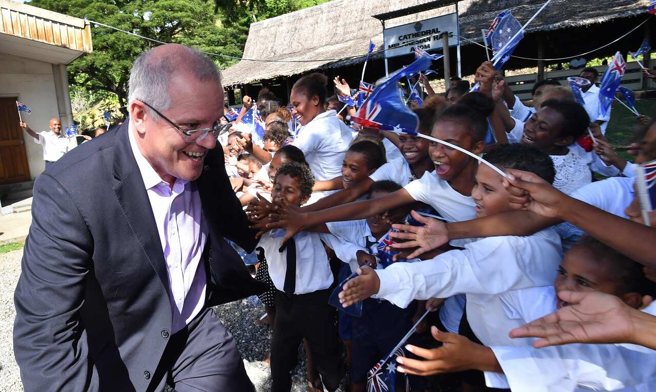 Prime Minister Scott Morrison is seen with children at St Barnabas Anglican Cathedral in Honiara in the Solomon Islands.