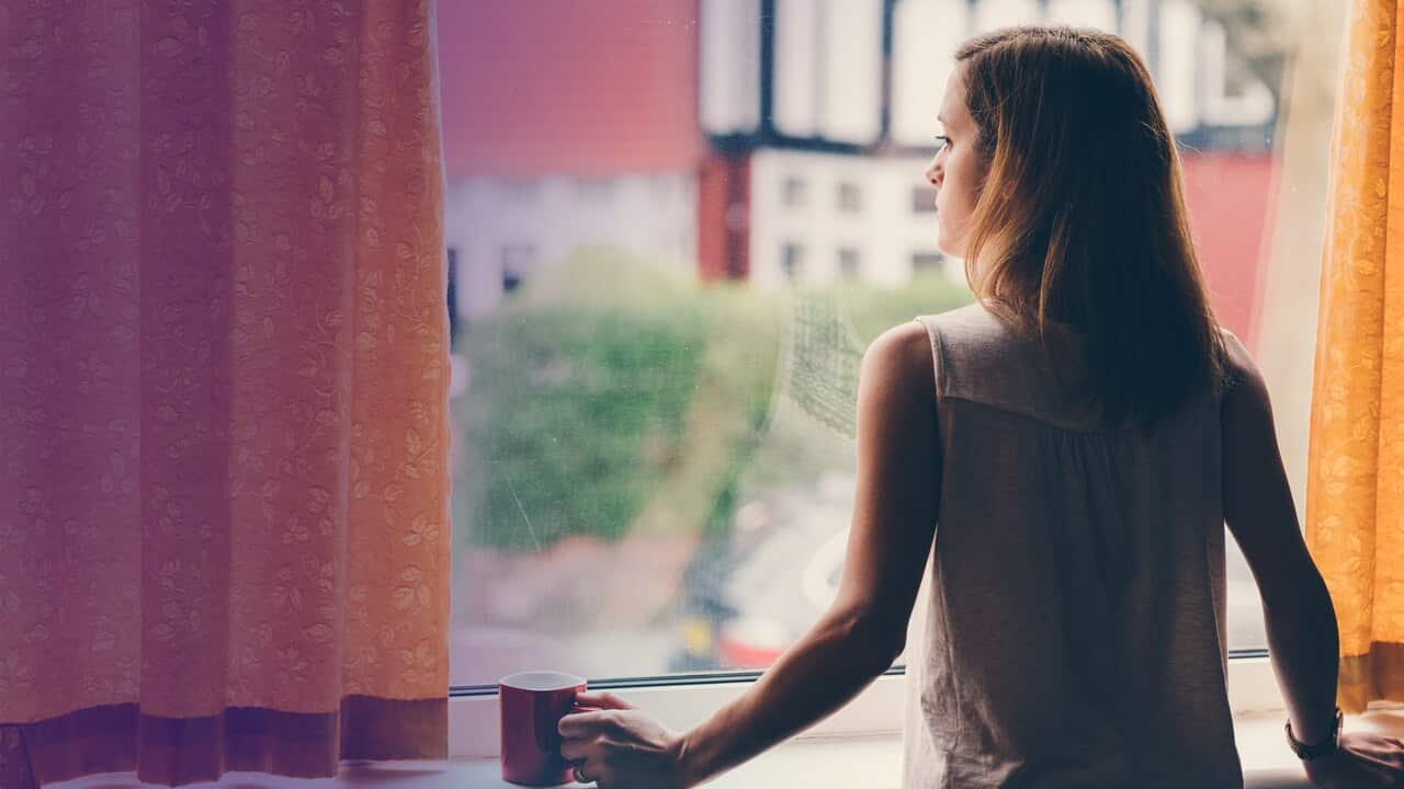 Lady looking out a window