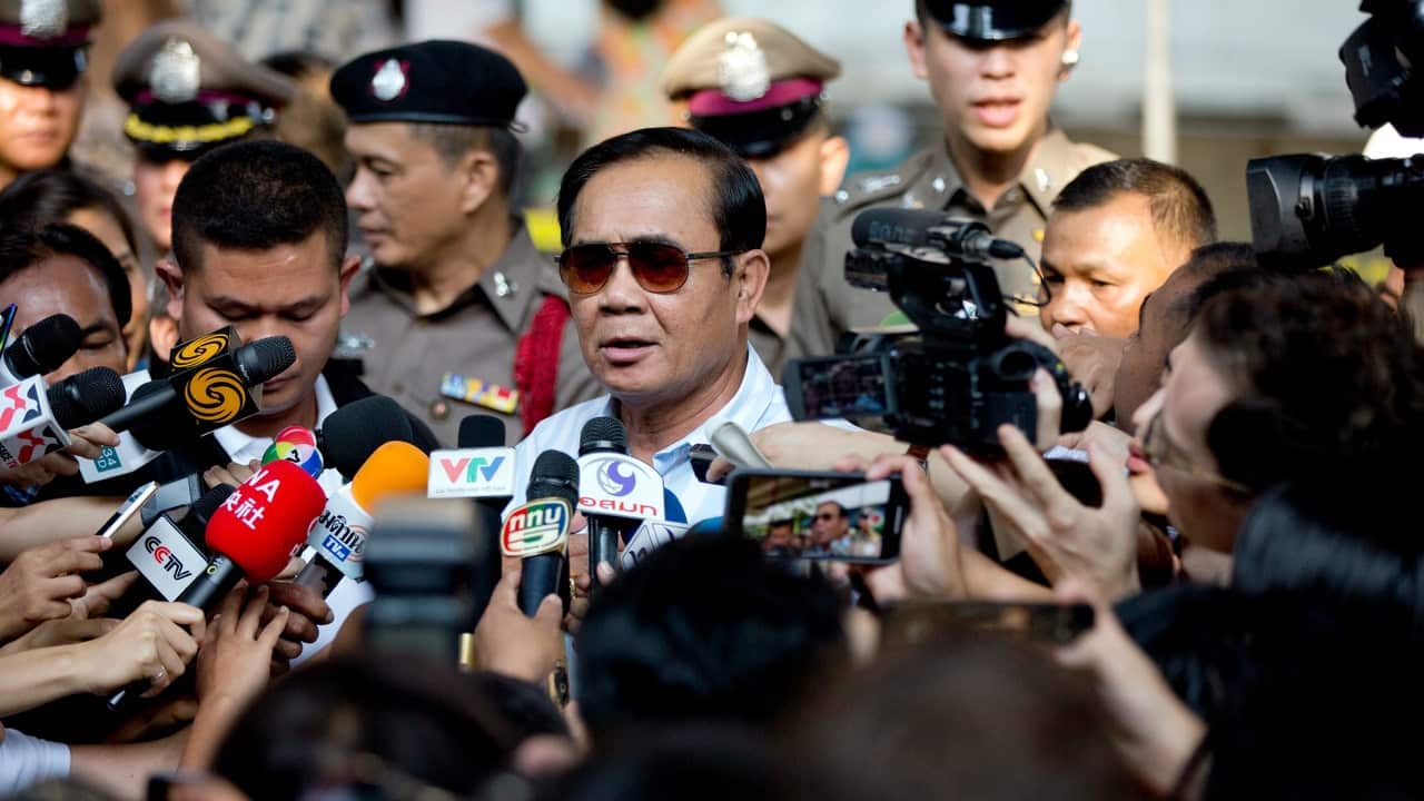 Thailand's Prime Minister Prayuth Chan-ocha speaks to journalists after casting his vote at a polling station in Bangkok.