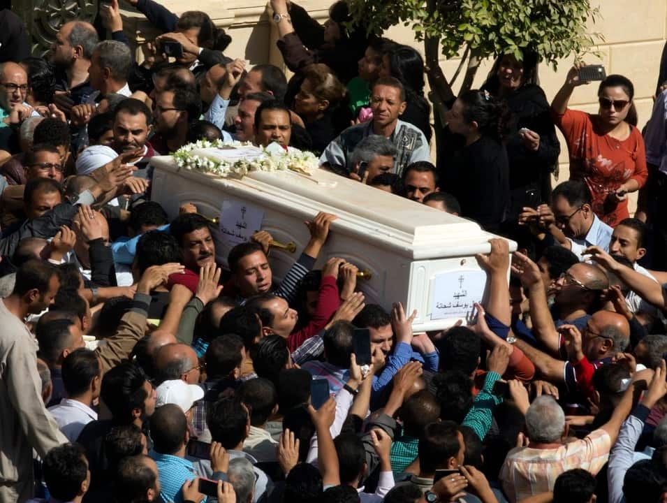 Relatives and friends carry the coffins of one of the victims of the bus shooting.