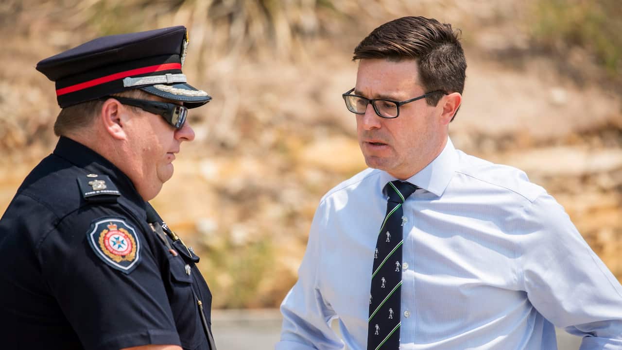 Minister for Natural Disaster and Emergency Management David Littleproud (right) speaks Superintendent Tyson Loetzsch at Ripley Fire Station in Ipswich.