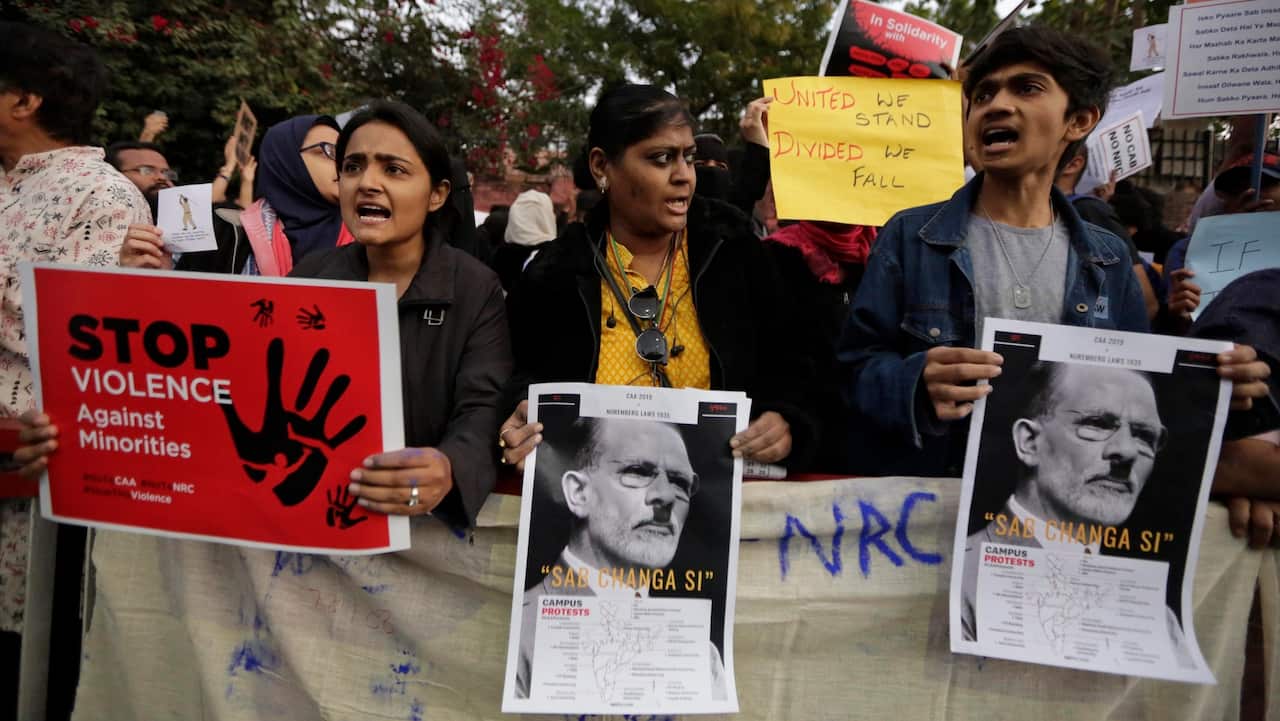 Indians holds placards and shouts slogans during a protest against a new citizenship law out side Gandhi Ashram in Ahmadabad, India.