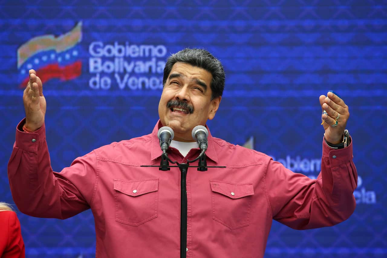 Venezuela's President Nicolas Maduro talks to journalist covering his vote in elections.