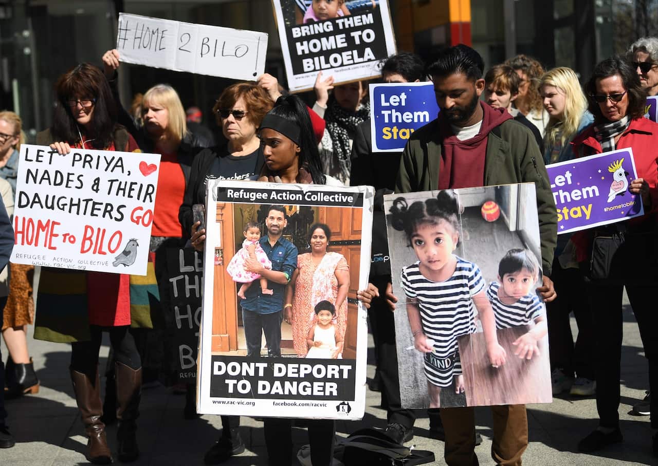 Supporters of the family gather outside the Federal Court in Melbourne.
