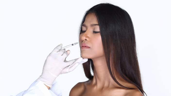 Beautiful Dark Tan Skin Woman with Medical healthy beauty Injection Treatment