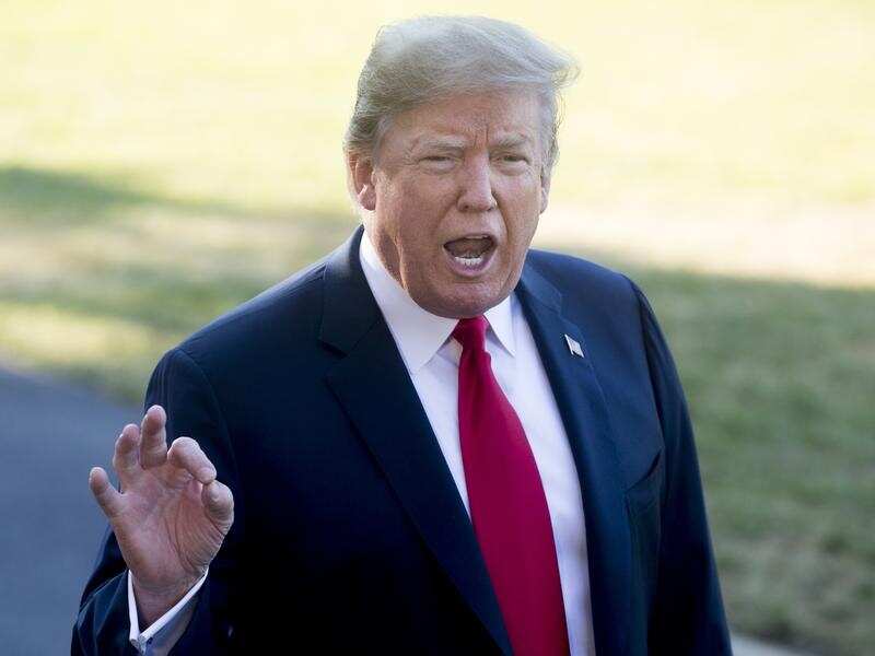 US President Donald Trump speaks to the media outside the White House.