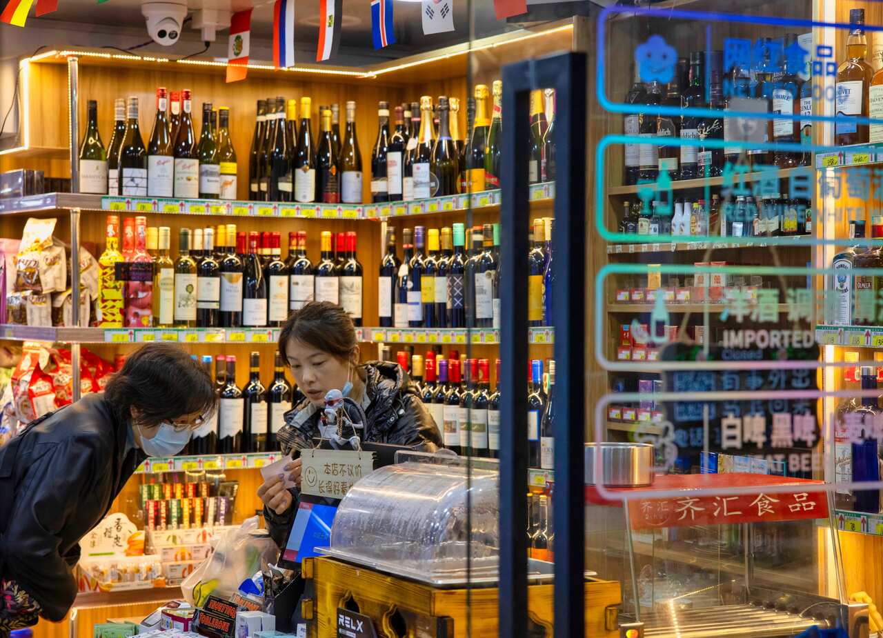 A woman shops at an imported food and wine shop in Shanghai, China, on 27 November.