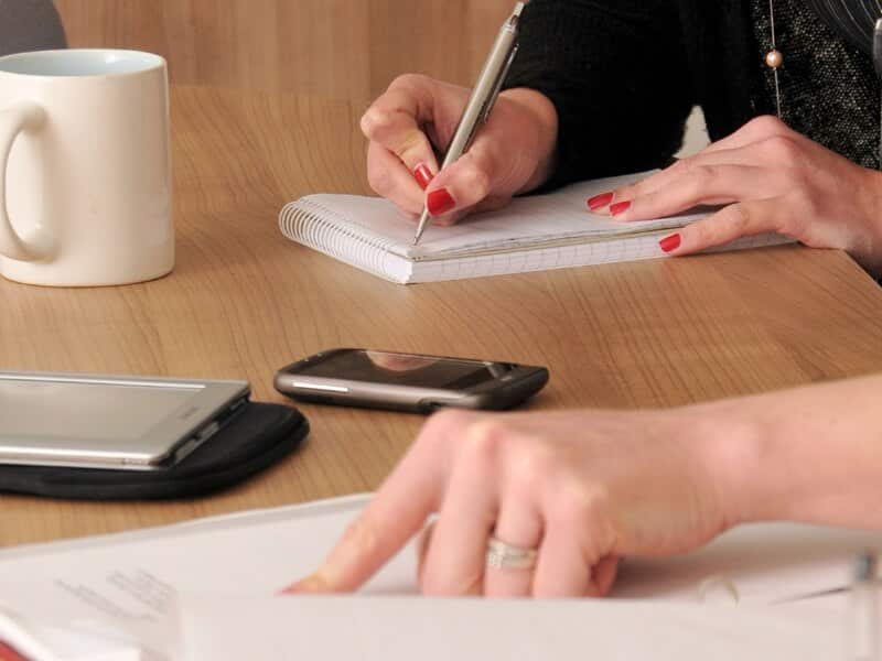 people making notes during a meeting