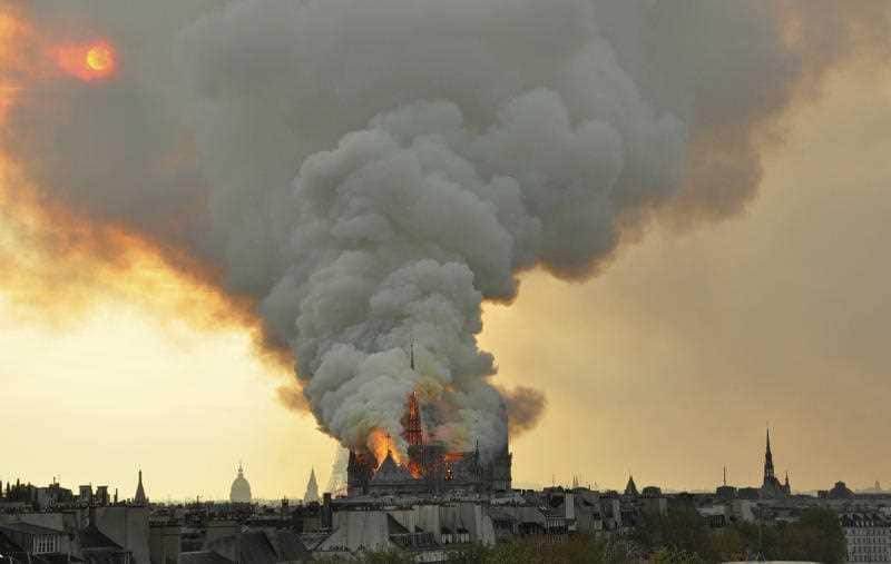 Notre-Dame burns as firefighters rush to scene. 