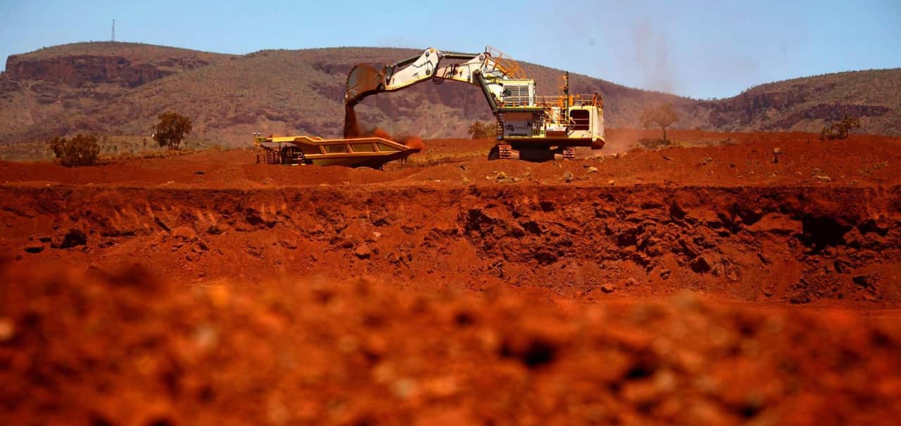 A giant excavator loads a mining truck at the Fortescue Solomon iron ore mine located in the Sheila Valley, around 400 km south of Port Hedland, in the Pilbara region of Western Australia December 2, 2013. REUTERS/David Gray