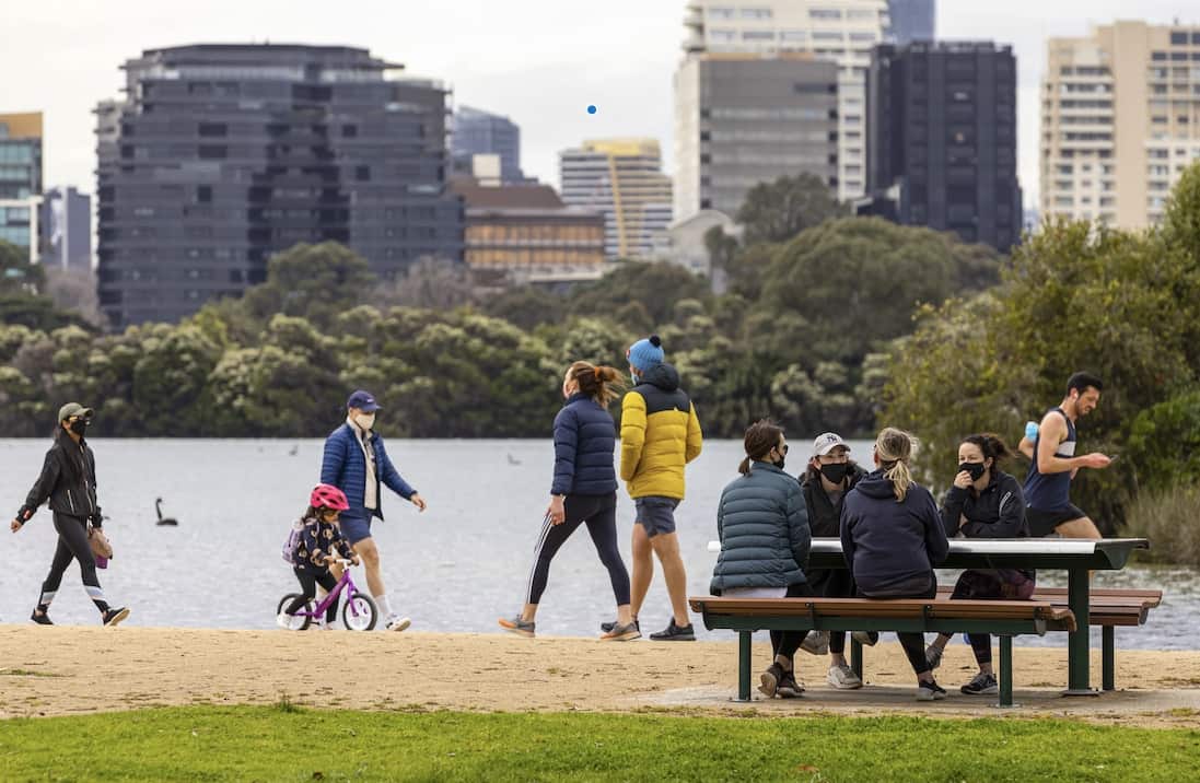 People are seen exercising and socialising at Albert Park Lake in Melbourne, 19 September 2021.