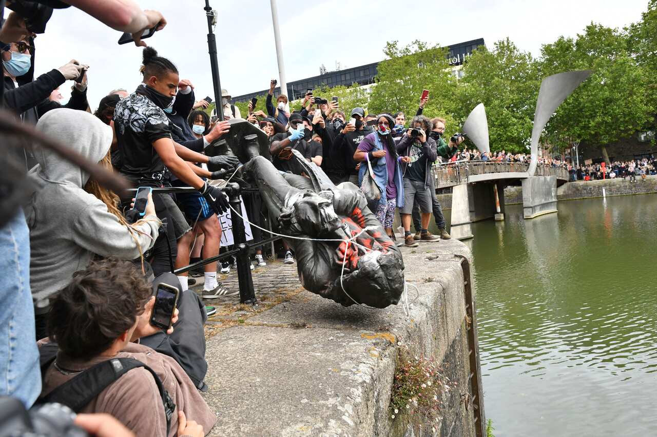 Protesters throw a statue of slave trader Edward Colston into Bristol harbour, during a Black Lives Matter protest rally, in Bristol, England. 