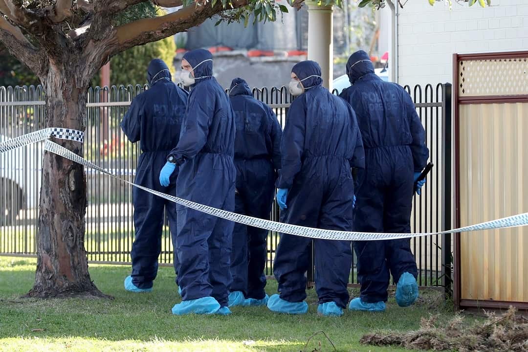 Forensic police officers inspect a property in Bedford, Perth after five bodies were discovered at the home.