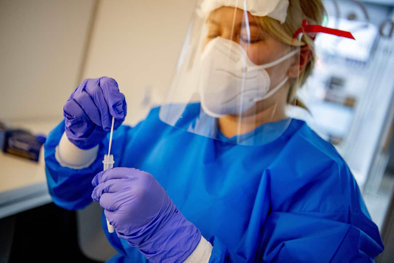 A health worker helps conduct a rapid antigen test in Utrecht, Netherlands.