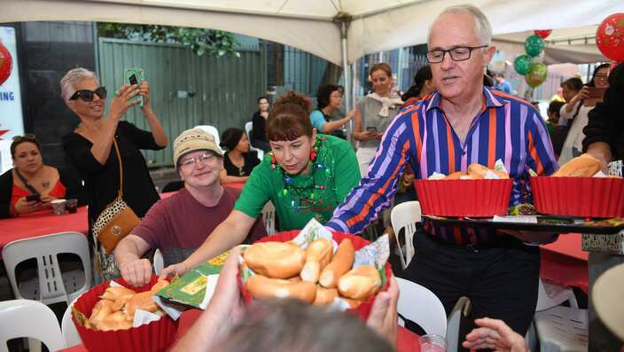 Australian Prime Minister Malcolm Turnbull serves meals during the annual Wayside Chapel Christmas lunch  