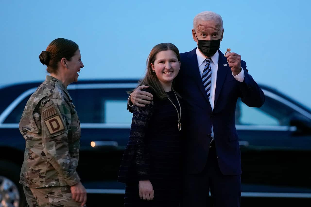 President Joe Biden poses before boarding Air Force One en route to the G7 summit