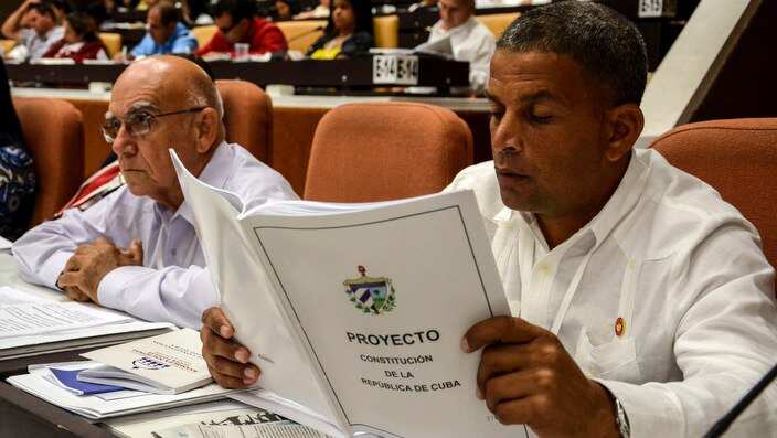 A member of the National Assembly studies the proposed update to the Constitution, in Havana.