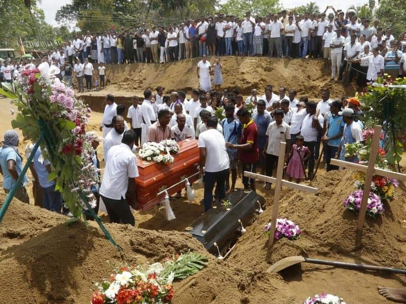 Relatives and friends bury victims of the bomb blasts in Colombo.