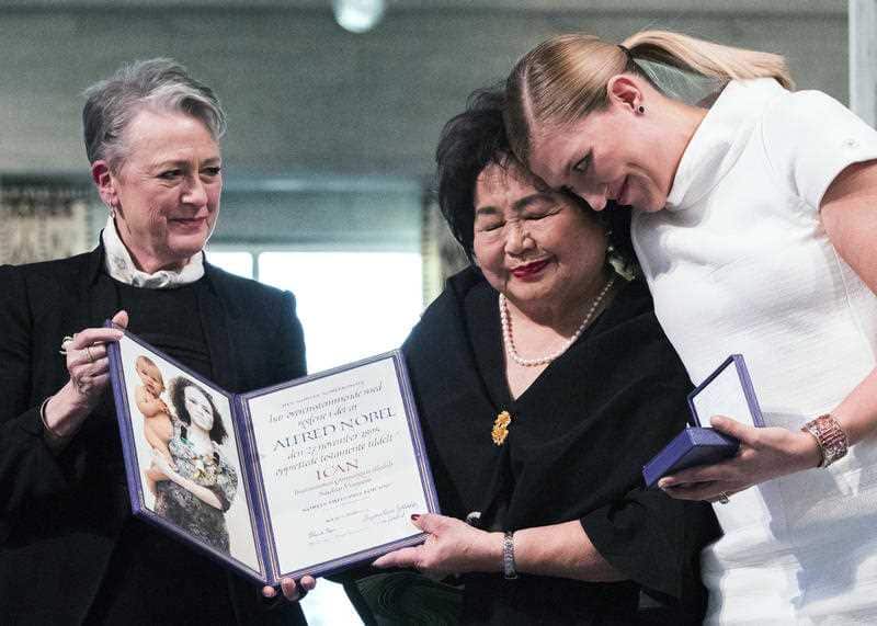 Leader of the Nobel committee Berit Reiss-Andersen, left, presents the award to Hiroshima Survivor Setsuko Thurlow and Beatrice Fihn, leader of ICAN