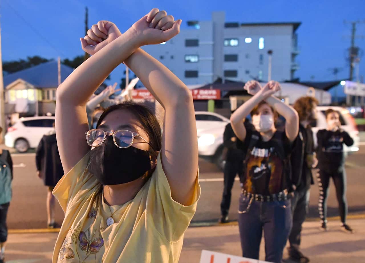 Protesters are seen outside the Kangaroo Point Central Hotel in Brisbane, Friday 12 June.