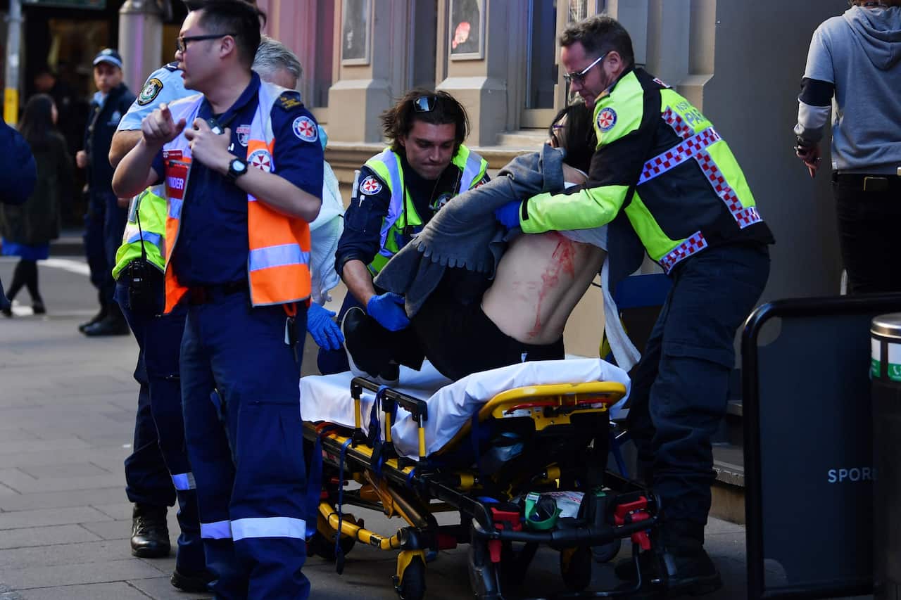 A women is taken by ambulance from Hotel CBD at the corner of King and York Street in Sydney, Tuesday, August 13, 2019. 