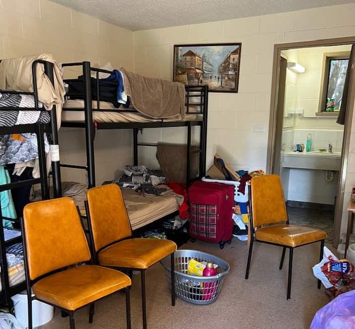 Four men each share one room with double bunk beds in Warburton, Victoria. No pantries, drawers or fans are provided.