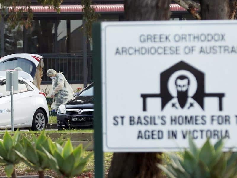 Medical staff are seen outside the St Basil's Home for the Aged.