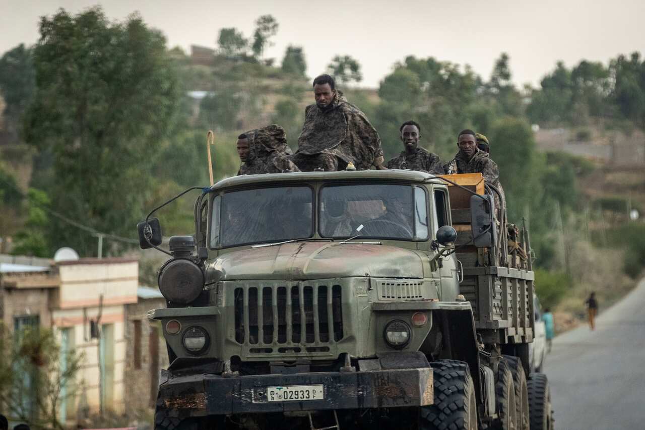 Ethiopian government soldiers ride in the back of a truck on a road leading to Abi Adi, in the Tigray region of northern Ethiopia.