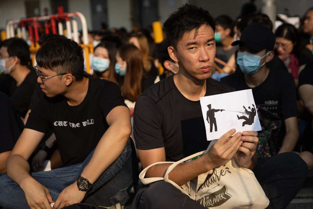 Protesters outside the Tsuen Wan Public Ho Chuen Yiu Memorial College during a demonstration held to show solidarity with an injured student, in Hong Kong