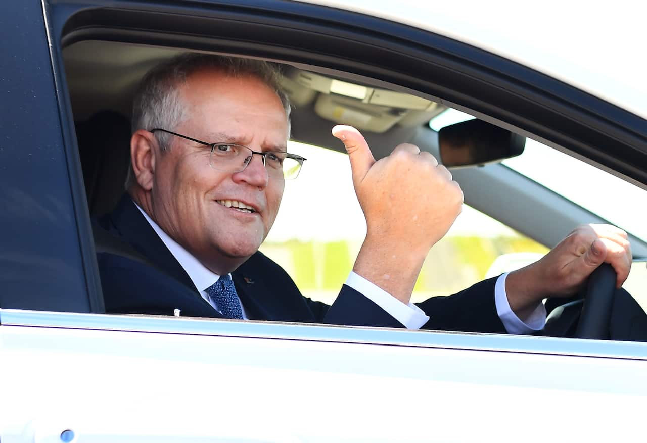 Prime Minister Scott Morrison drives a hydrogen-fuelled car around a Toyota test track in Melbourne.