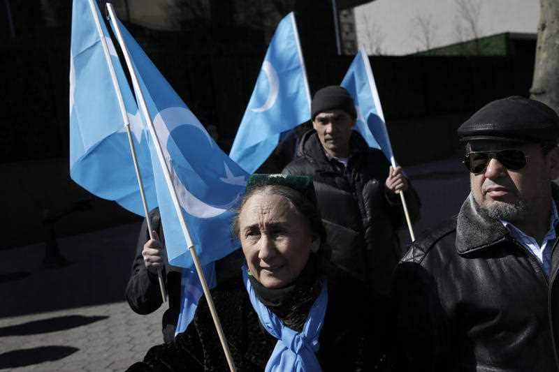 Uighurs and their supporters rally across the street from United Nations headquarters in New York, Thursday, March 15, 2018.