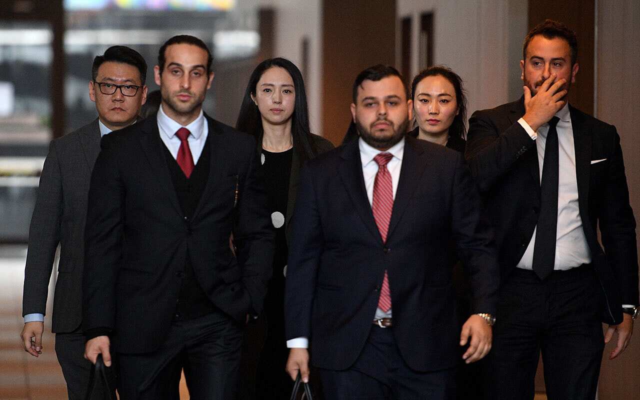 Xuan Dong (third left), the wife of Chinese actor Yunxiang Gao, leaves the NSW Supreme Court in Sydney, Friday, June 29, 2018. 