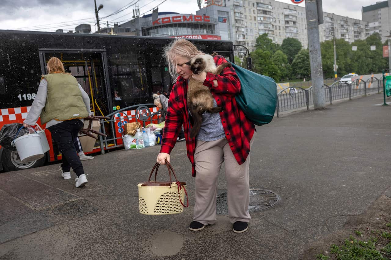 A woman leaves a metro station where people had been living underground for months in Kharkiv, Ukraine