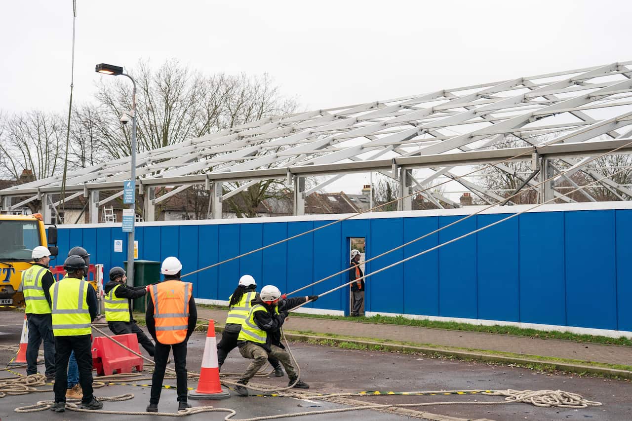 Construction workers at work building a Nightingale 'surge hub' at St George's Hospital, in south west London on 30 December, 2021.