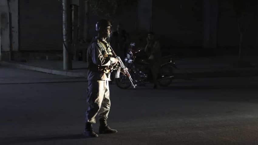 An Afghan police officer stands guard after an explosion in Kabul where dozens of people are feared dead.