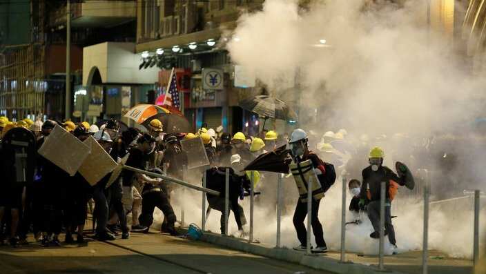 Hong Kong protesters react to teargas.