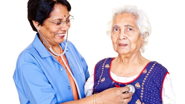 Series - Cheerful Senior Indian Female Doctor examining aged patient