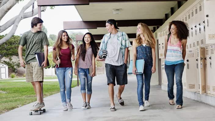 School friends walking in portico