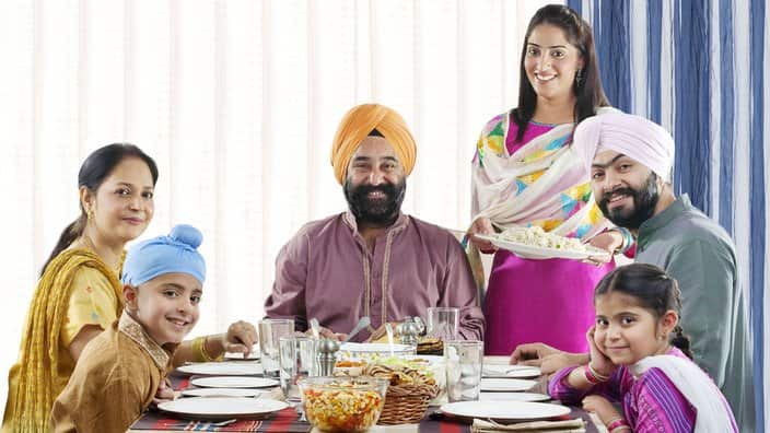 Sikh family having lunch at the dinner table