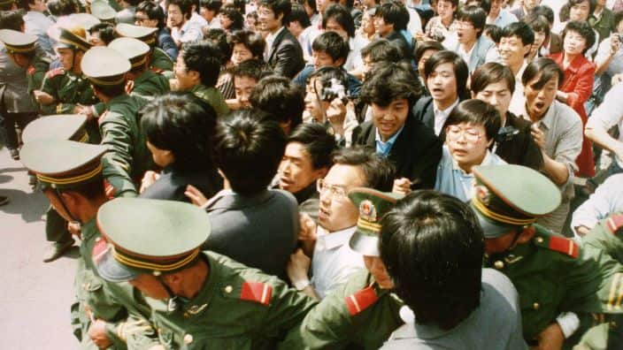 Crowds of jubilant students surge through a police cordon before pouring into Tiananmen Square on June 4, 1989 during a pro-democracy demonstration. This year marks the 10th anniversary of the bloody June 4 1989 army crackdown on the pro-democracy movemen