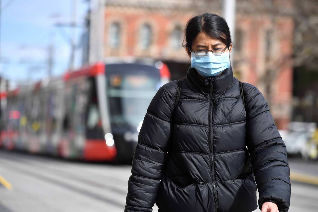 A pedestrian wearing a face mask in Sydney