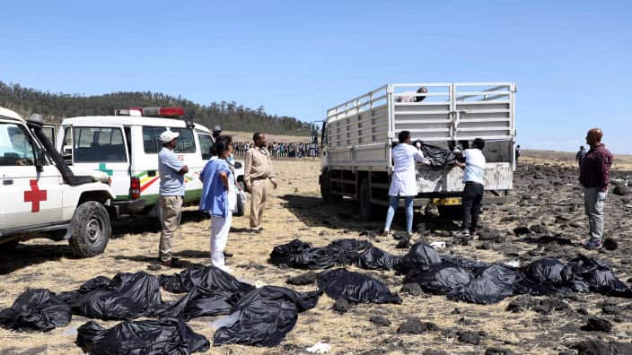 Rescuers remove body bags from the scene of an Ethiopian Airlines flight that crashed shortly after takeoff at Hejere near Bishoftu.