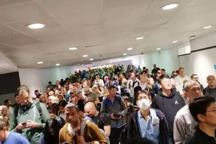 Thousands fill the arrivals hall at Sydney Airport