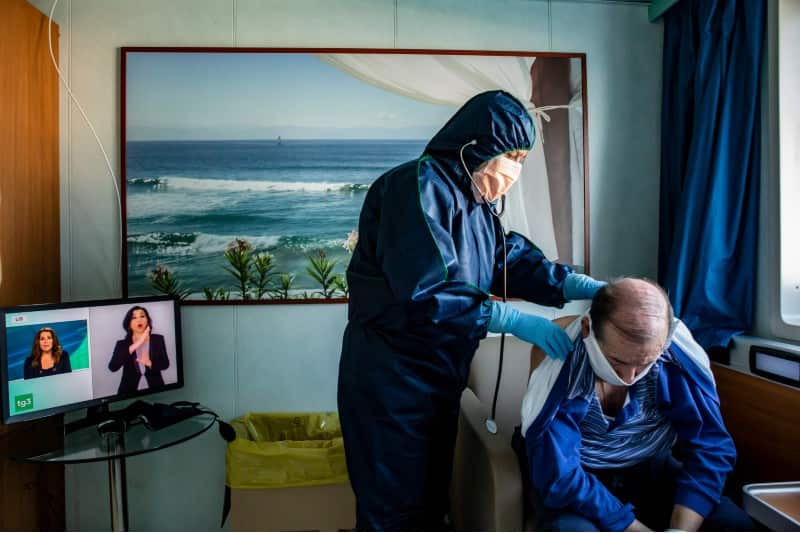 A doctor in PPE checks on a Covid-19 patient on board the MV Splendid converted in a Covid-19 hospital in Genoa, Italy.