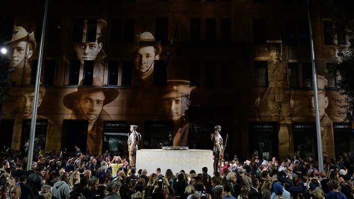 Projections are seen on a building behind the cenotaph during the Anzac Day dawn service in Sydney, Friday, April 25, 2014. This year marks the 99th anniversary of Australian forces landing at Gallipoli.