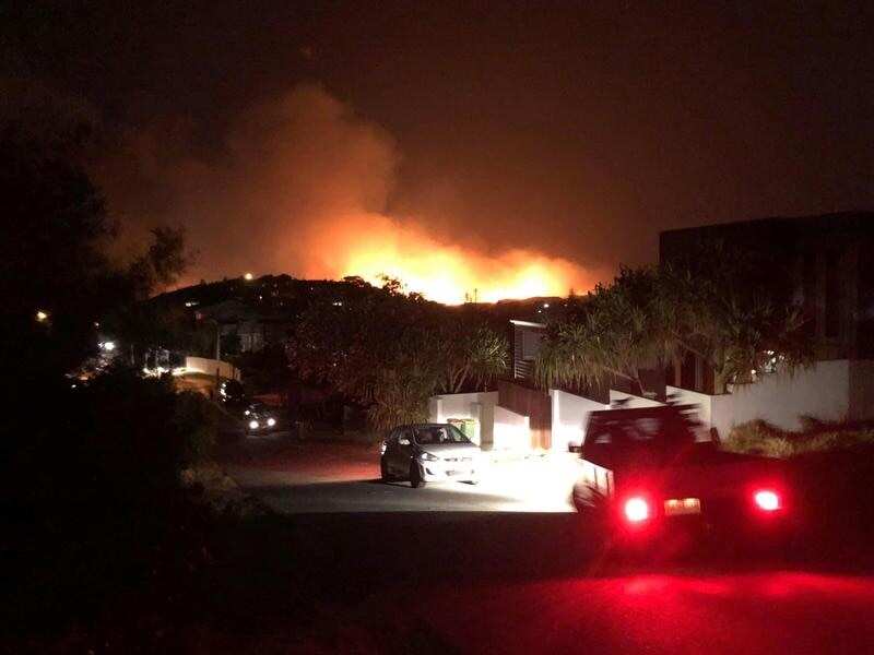 A fire rages in bushland over Peregian Springs in Queensland.