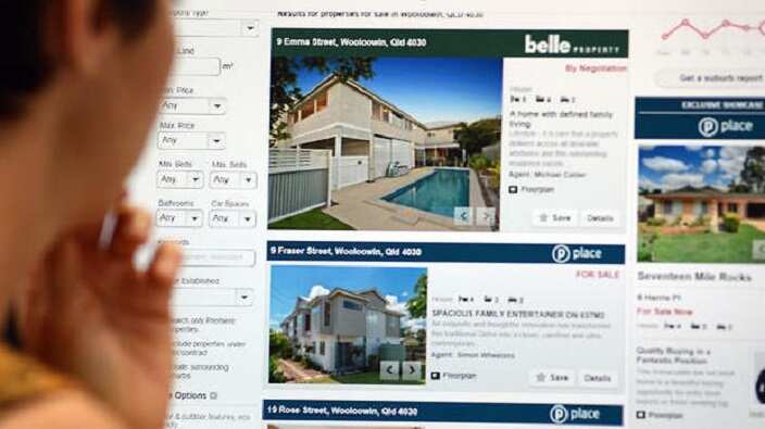 A woman looks at real estate advertising on an internet website